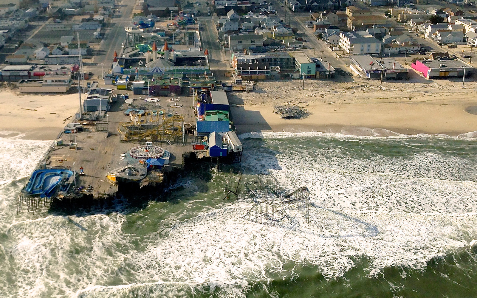 Aerial view of hurricane damage to a pier and other buildings along the U.S. coast