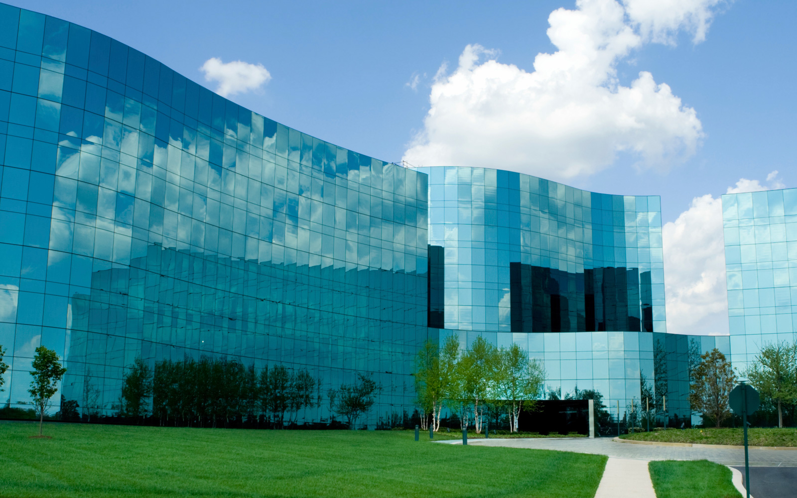 Exterior of large modern office building with tinted glass windows.