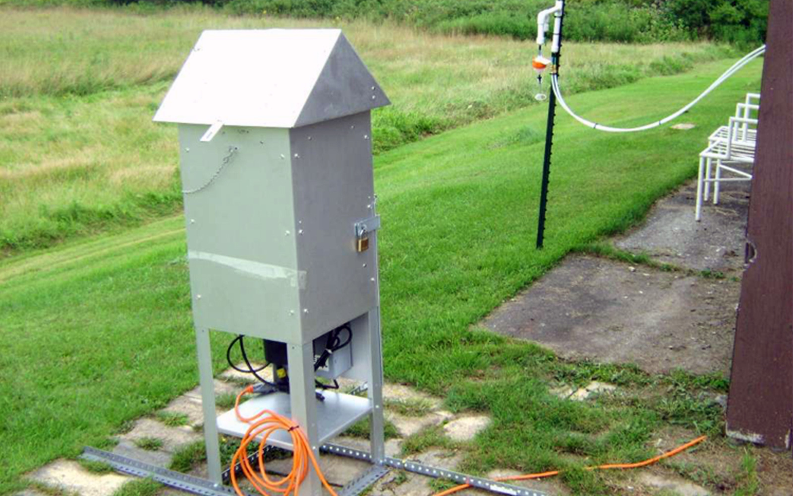 Air monitoring device situated in a yard just outside a home 