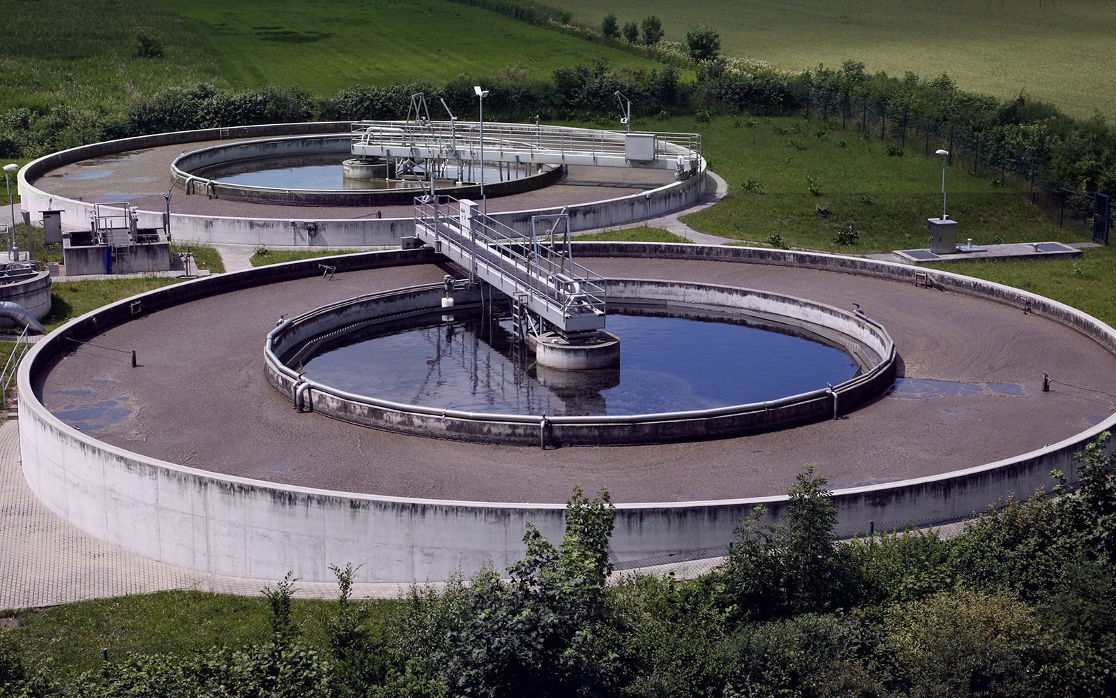 Aerial view of two large circular wastewater treatment tanks