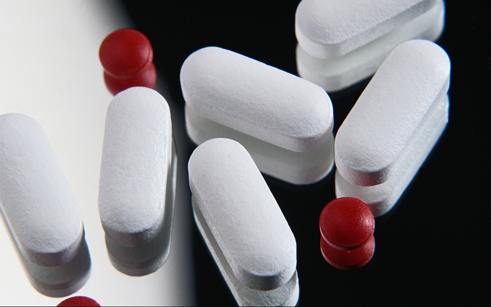 Close-up of FDA-regulated medication pills on a mirror