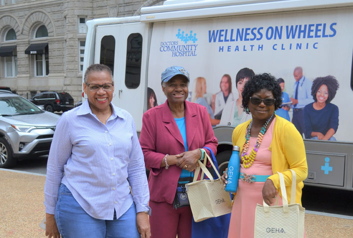 Three EPA employees waiting to get their blood pressure checked on the “Wellness on Wheels” Health Clinic Van, provided by Doctors Community Hospital