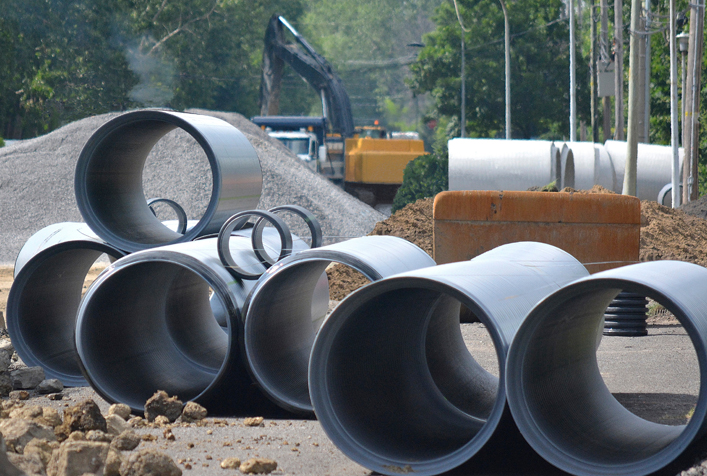 Photo of wastewater drainage pipes stacked at construction site
