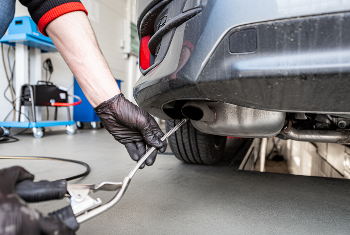 photo of emission inspection on tailpipe of an automobile
