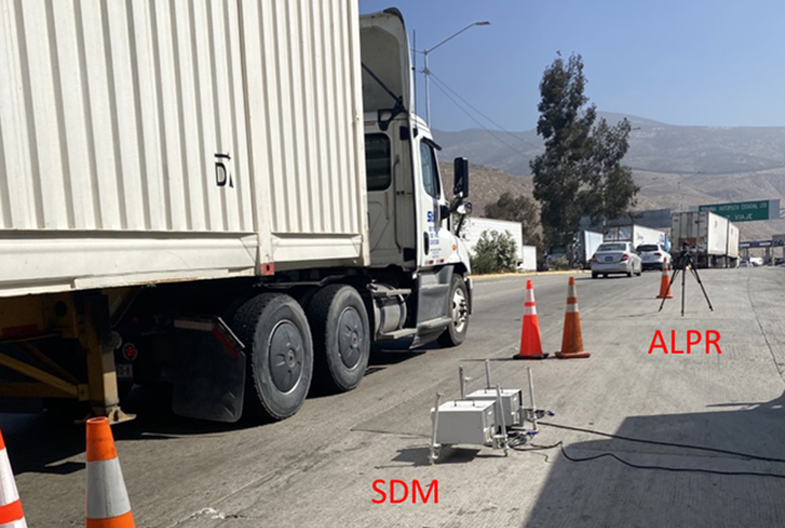 photo of 18-wheeler truck with air monitoring equipment on the ground next to it.