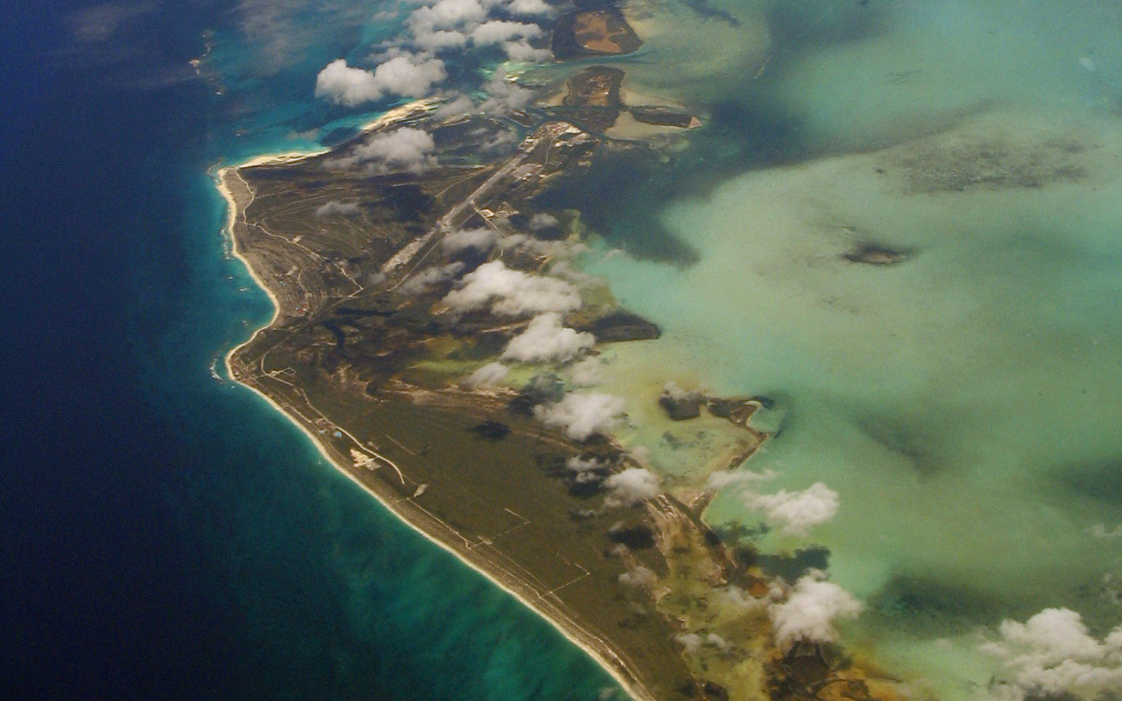 Aerial view of a Gulf Coast barrier island surrounded by blue-green ocean water