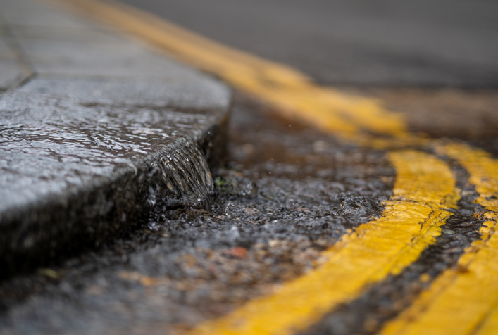 Photo of a street curb showing water runoff